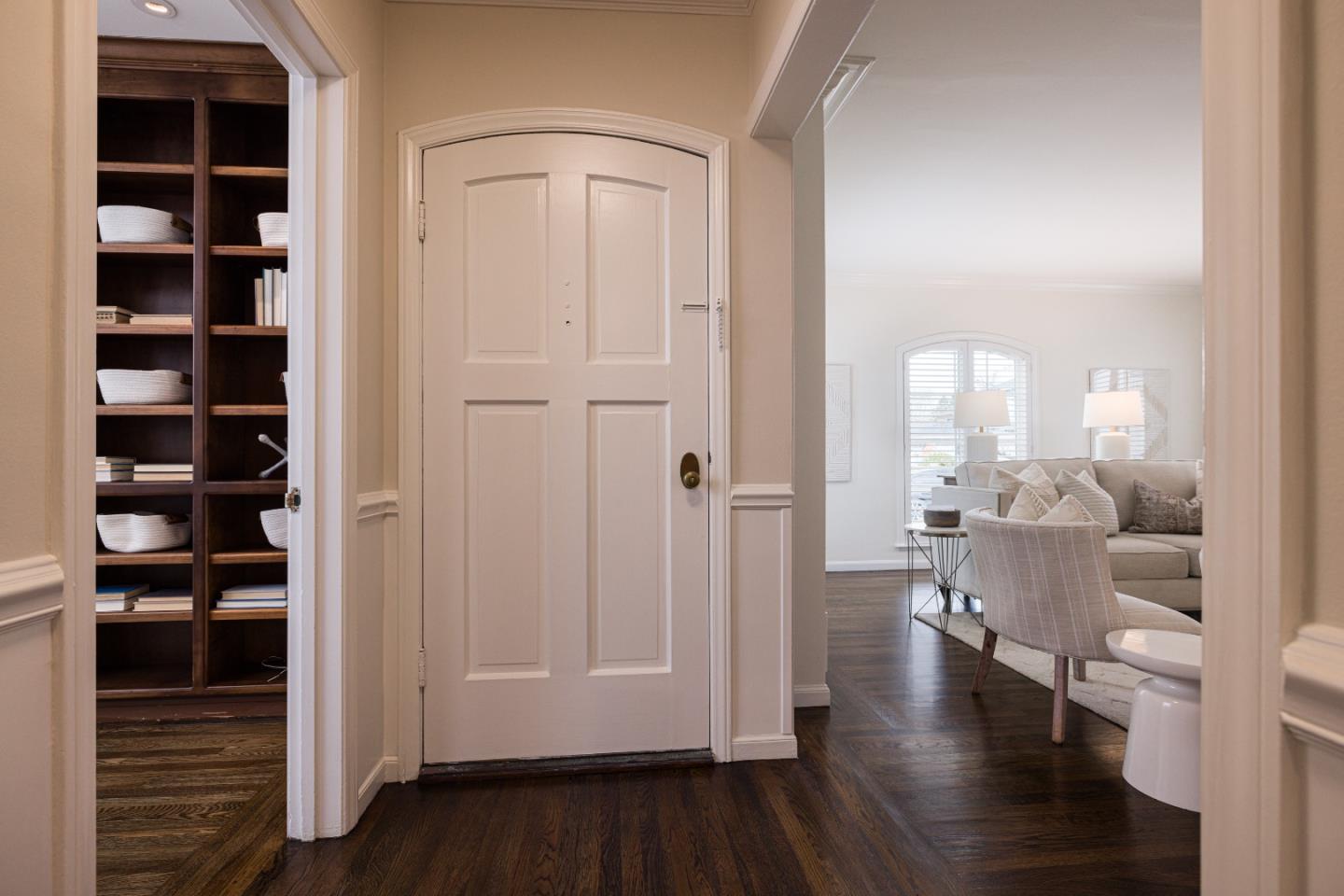 628 Alhambra Road San Mateo, CA 94402 - Photo 2 of 35 a view of a hallway with wooden floor and windows