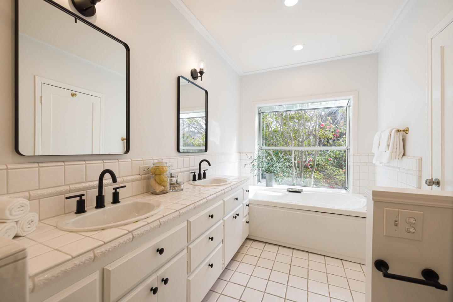 628 Alhambra Road San Mateo, CA 94402 - Photo 21 of 35 a bathroom with a double vanity sink toilet mirror and window