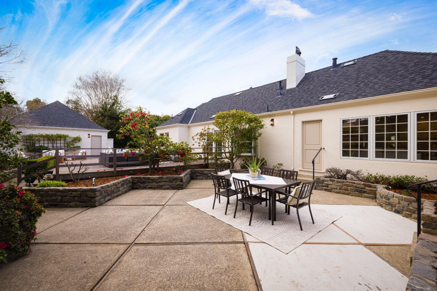 628 Alhambra Road San Mateo, CA 94402 - Photo 29 of 35 a view of a patio with dining table and chairs under an umbrella