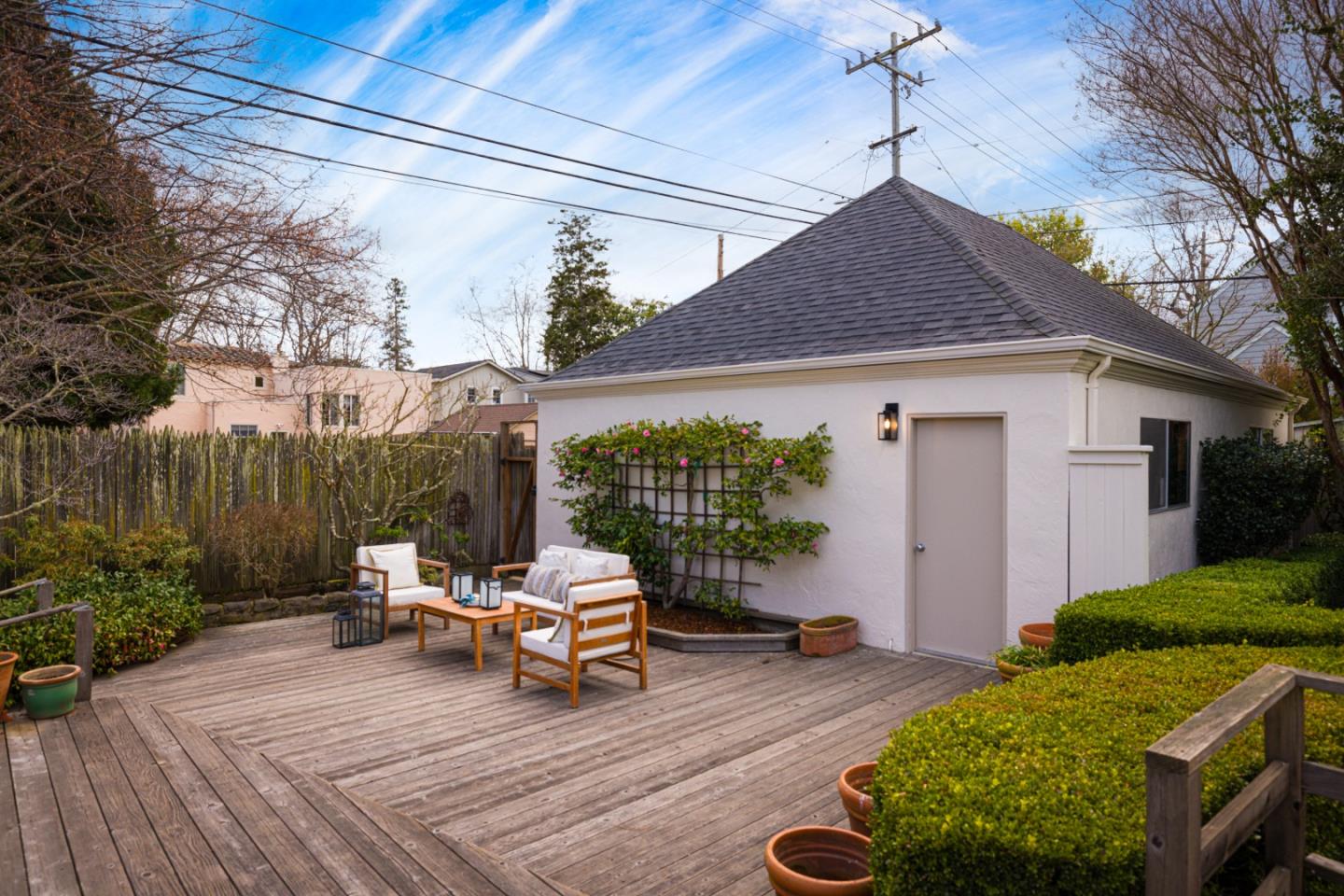 628 Alhambra Road San Mateo, CA 94402 - Photo 32 of 35 a view of a patio with table and chairs potted plants and large tree