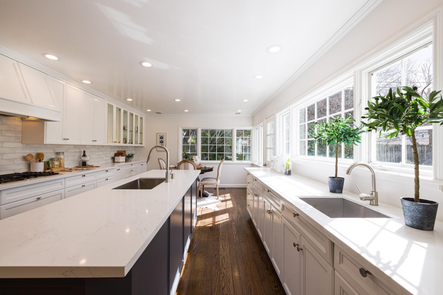 628 Alhambra Road San Mateo, CA 94402 - Photo 10 of 35 a large kitchen with stainless steel appliances a sink a counter top space a large window and a potted plant