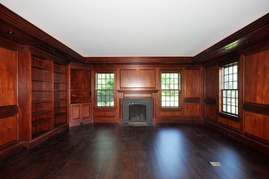 285 Musketaquid Road Concord, MA 01742 - Photo 15 of 30 an empty room with wooden floor fireplace and windows