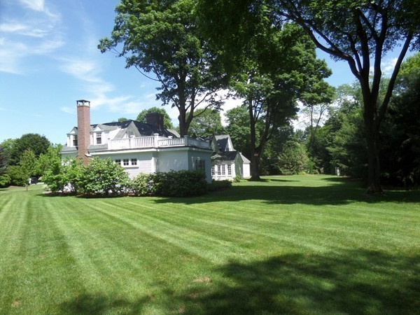 285 Musketaquid Road Concord, MA 01742 - Photo 26 of 30 a front view of a house with garden and trees