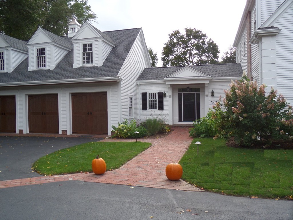 285 Musketaquid Road Concord, MA 01742 - Photo 6 of 30 a view of a brick house with a yard plants and large tree