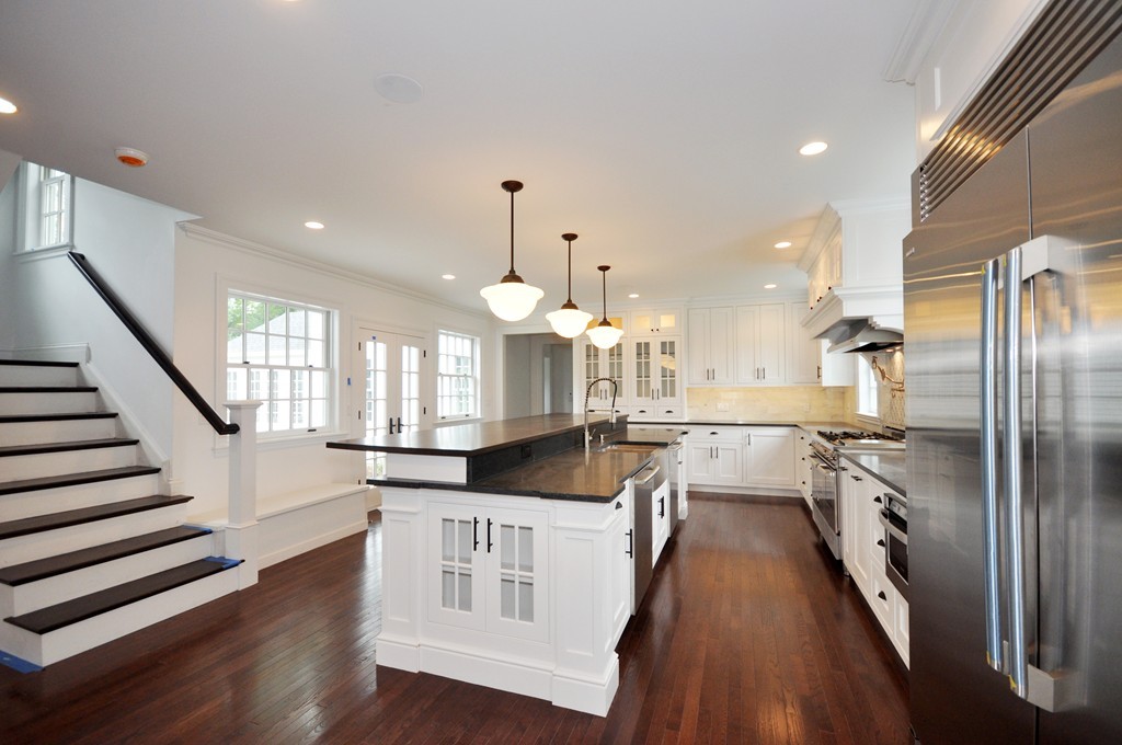 285 Musketaquid Road Concord, MA 01742 - Photo 9 of 30 a large kitchen with kitchen island a large counter space a sink appliances and cabinets