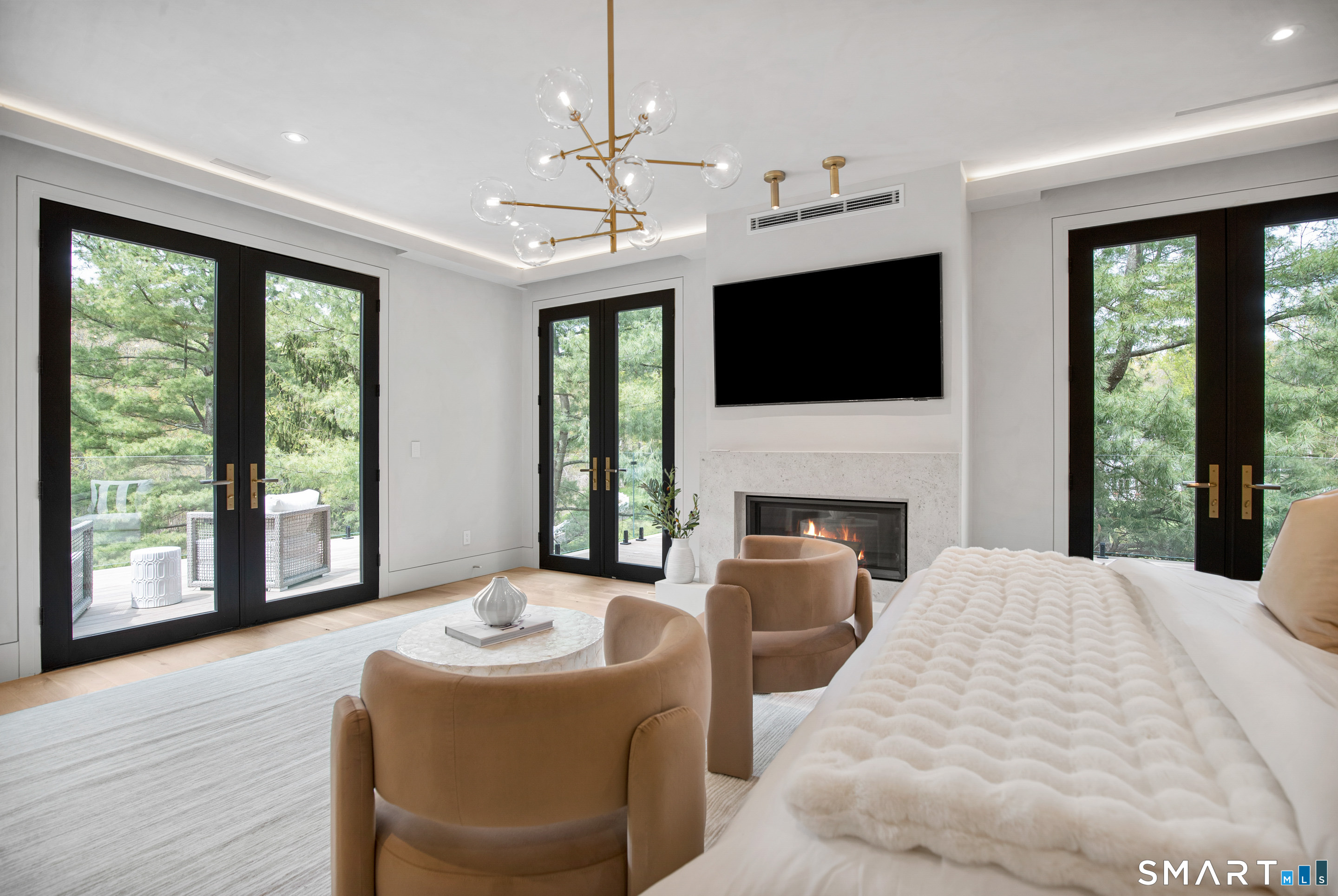 259 Frogtown Road New Canaan, CT 06840 - Photo 23 of 39 a living room with furniture a fireplace and a flat screen tv