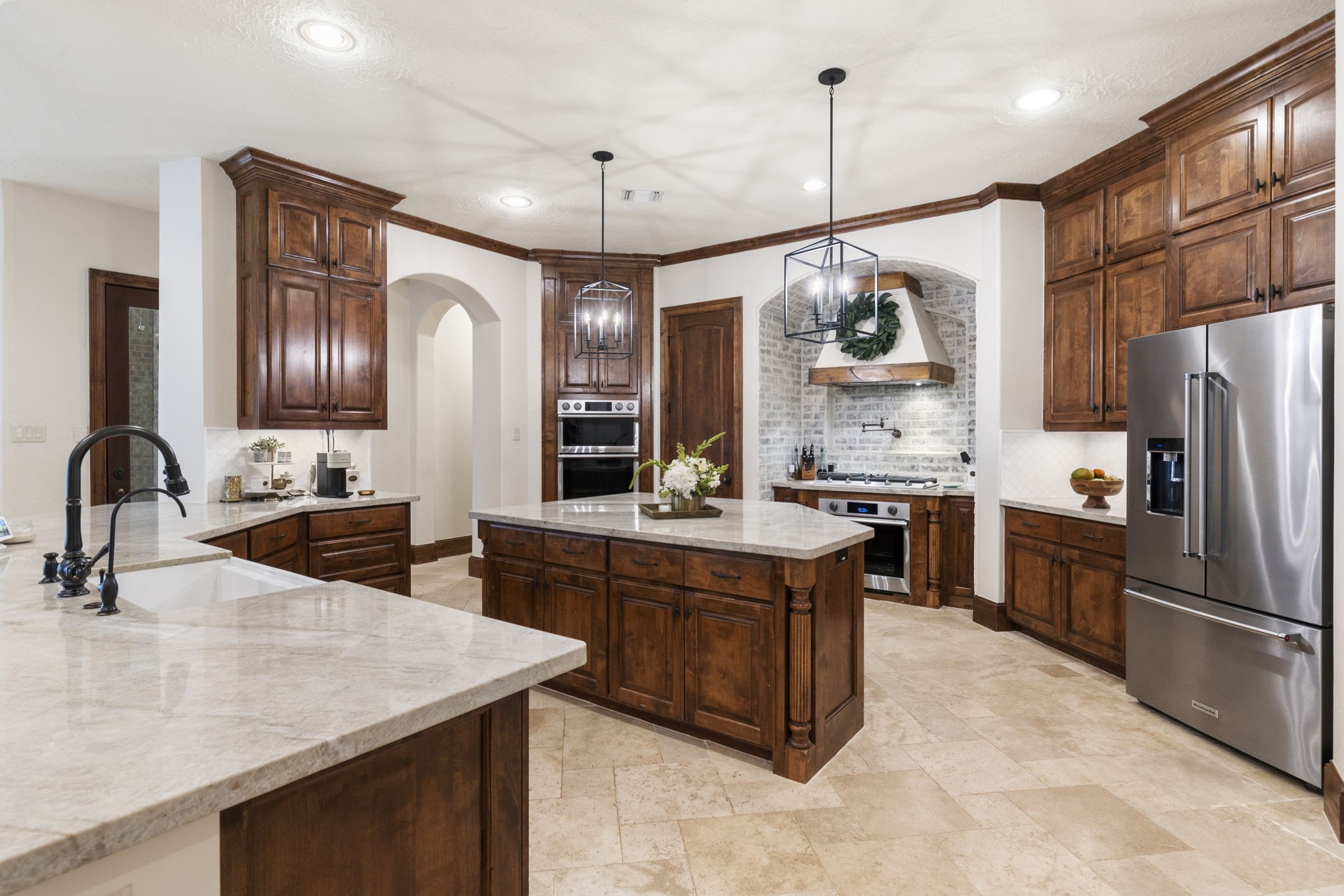 7421 Enchanted Stream Drive Conroe, TX 77304 - Photo 13 of 50 a kitchen with stainless steel appliances granite countertop a sink a stove and a refrigerator