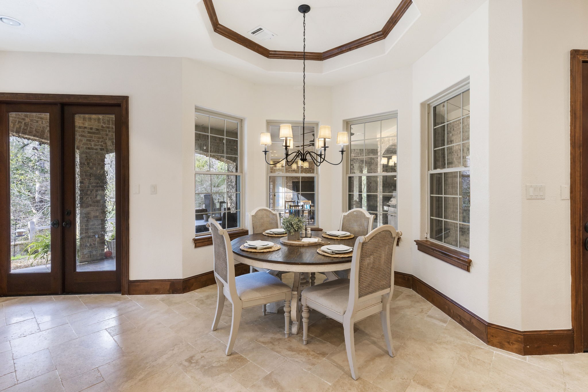 7421 Enchanted Stream Drive Conroe, TX 77304 - Photo 17 of 50 a dining room with furniture a chandelier and wooden floor
