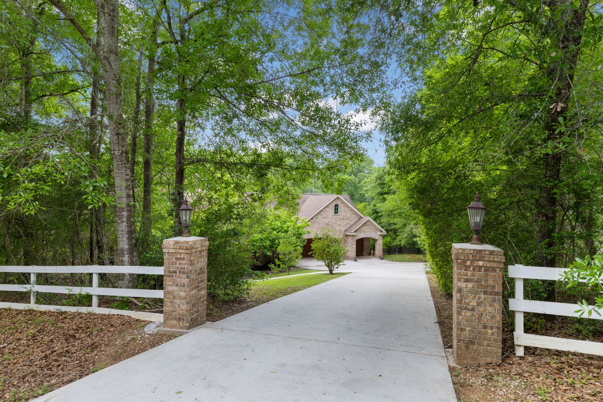 7421 Enchanted Stream Drive Conroe, TX 77304 - Photo 2 of 50 a view of a house with backyard and trees