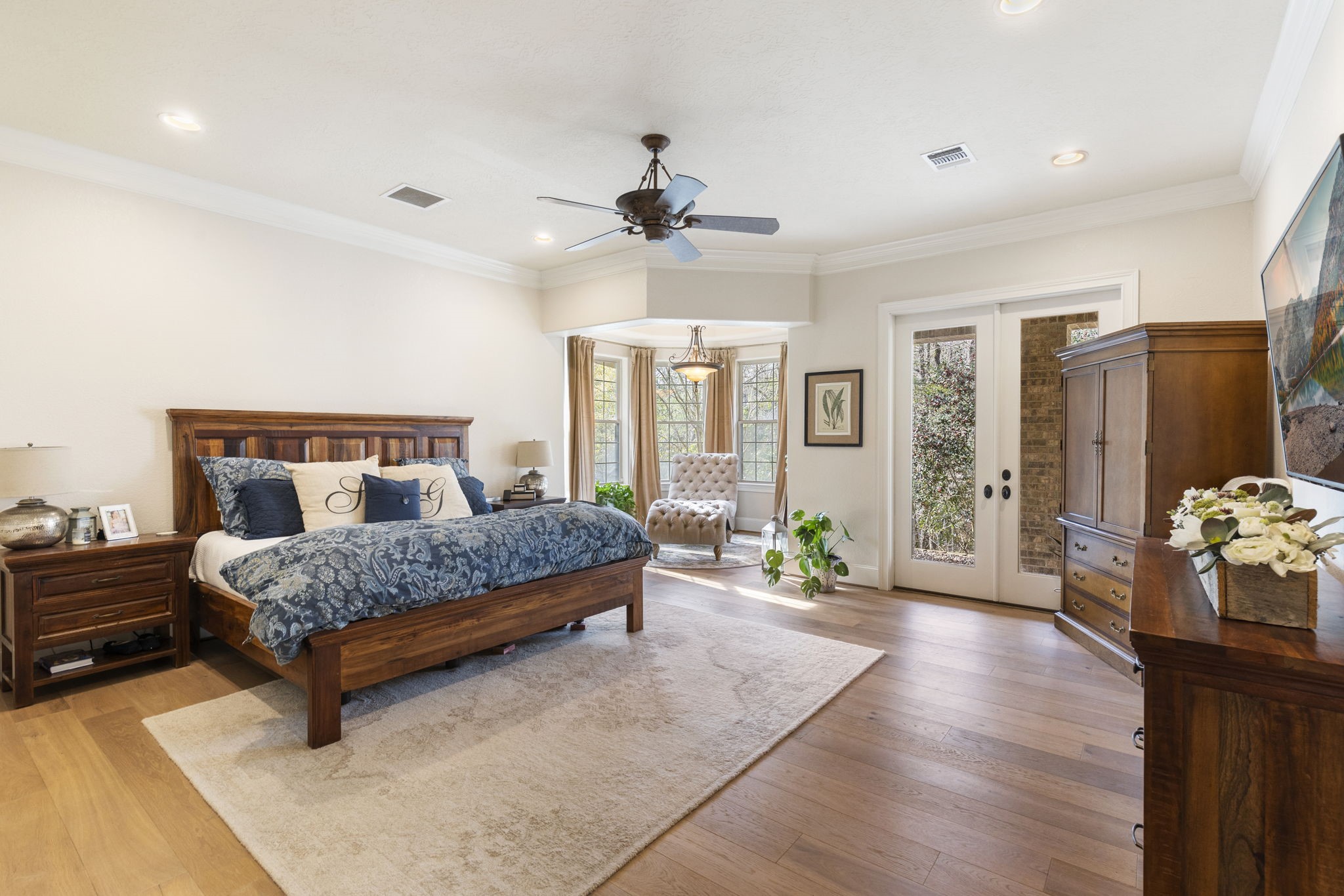7421 Enchanted Stream Drive Conroe, TX 77304 - Photo 22 of 50 a bedroom with a bed couch chandelier and window