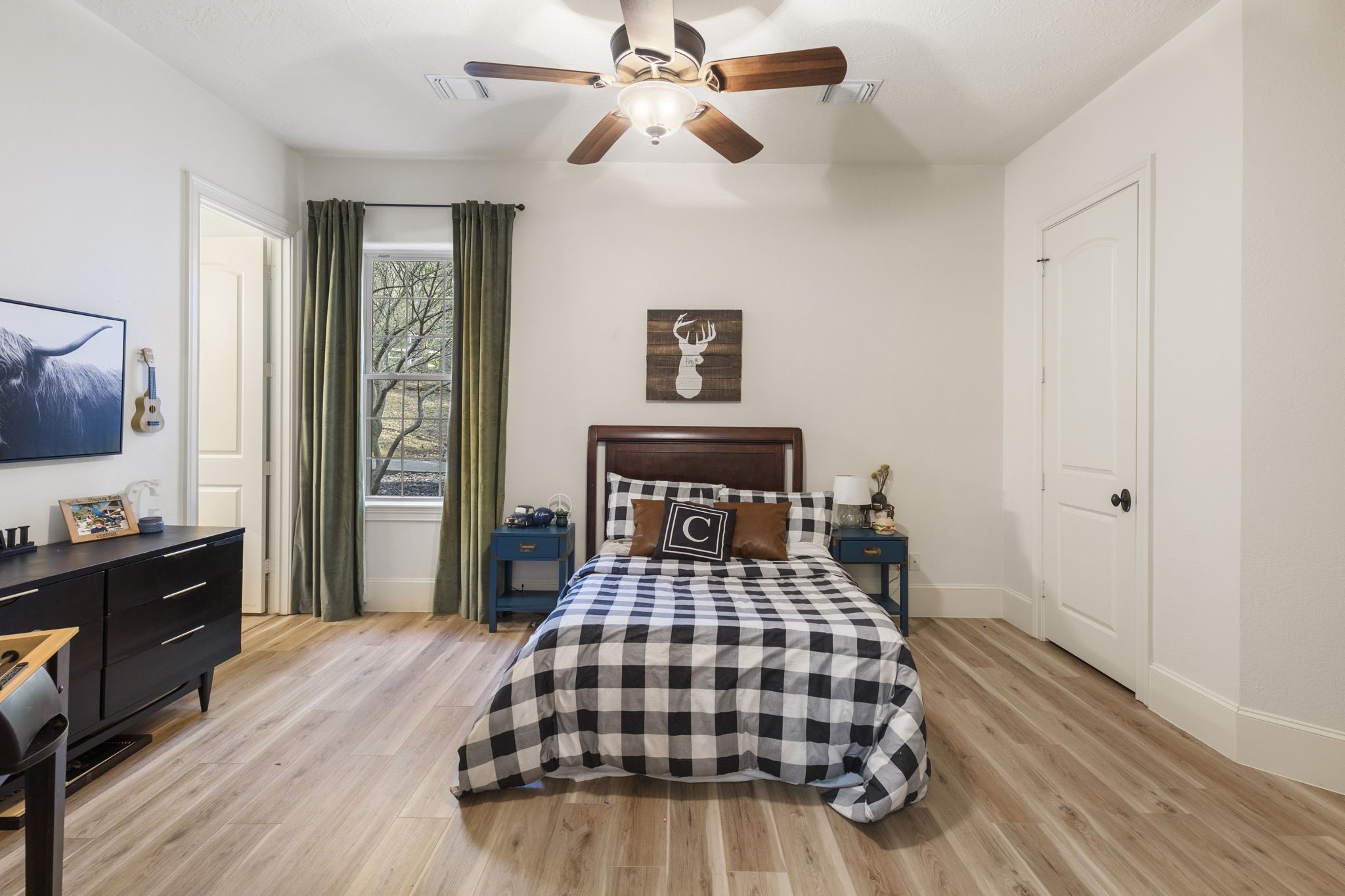 7421 Enchanted Stream Drive Conroe, TX 77304 - Photo 31 of 50 a bedroom with a bed and a dresser