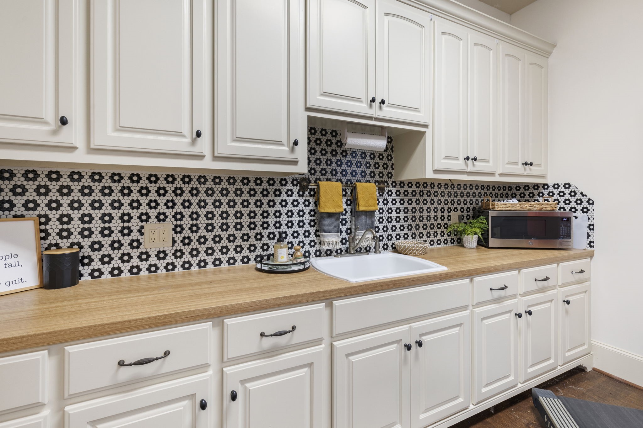 7421 Enchanted Stream Drive Conroe, TX 77304 - Photo 33 of 50 a kitchen with white cabinets and sink