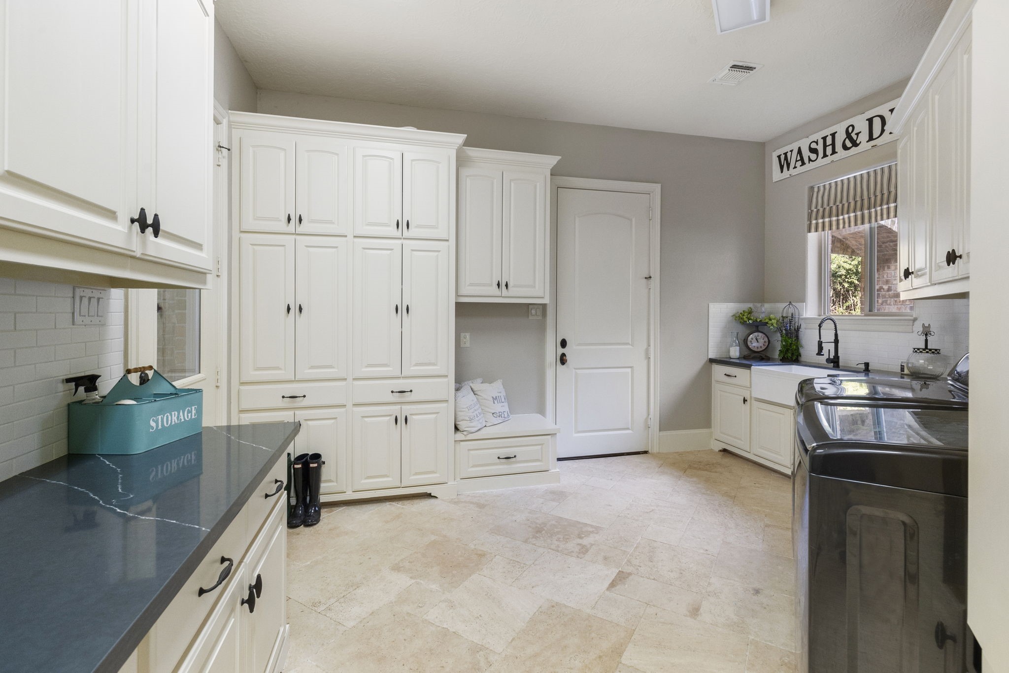 7421 Enchanted Stream Drive Conroe, TX 77304 - Photo 35 of 50 a kitchen with white cabinets and stainless steel appliances