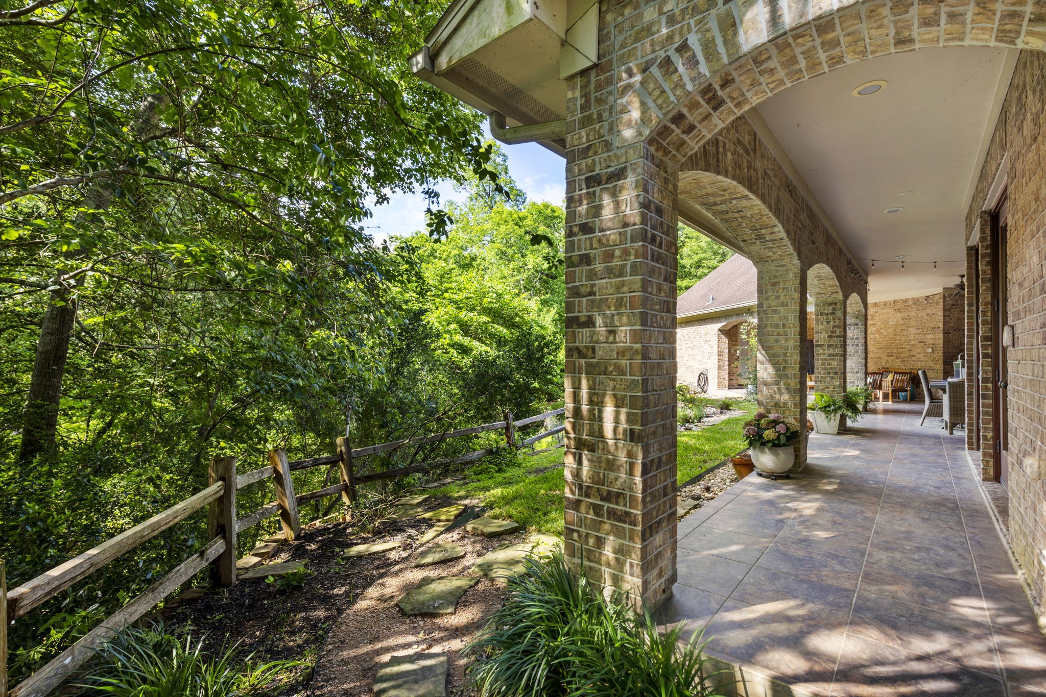 7421 Enchanted Stream Drive Conroe, TX 77304 - Photo 42 of 50 a view of a porch with couches and table with wooden floor