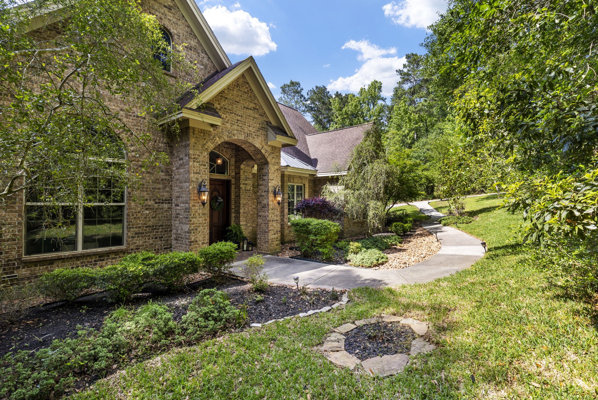 7421 Enchanted Stream Drive Conroe, TX 77304 - Photo 5 of 50 a front view of a house with a yard