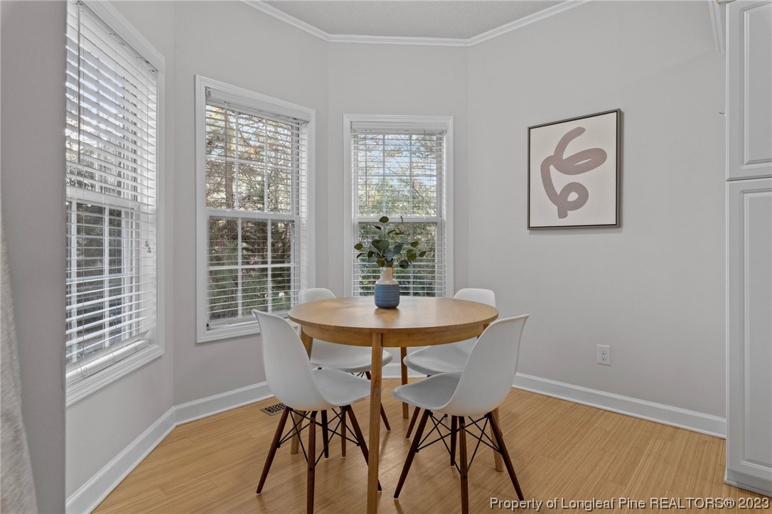 45 Sawmill Road West Pinehurst, NC 28374 - Photo 11 of 36 a view of a dining room with furniture and wooden floor