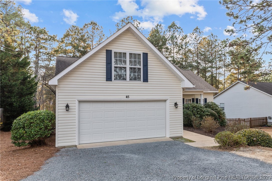 45 Sawmill Road West Pinehurst, NC 28374 - Photo 2 of 36 a view of a house with a yard and garage