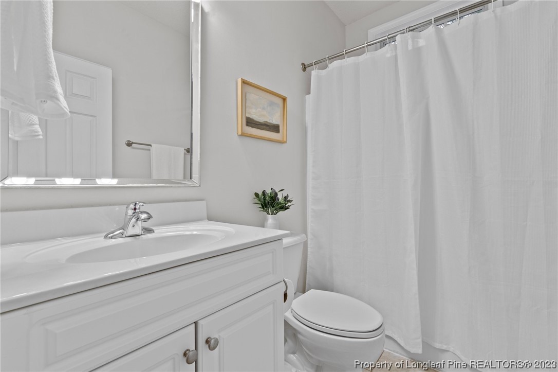 45 Sawmill Road West Pinehurst, NC 28374 - Photo 27 of 36 a bathroom with a sink a toilet and a mirror