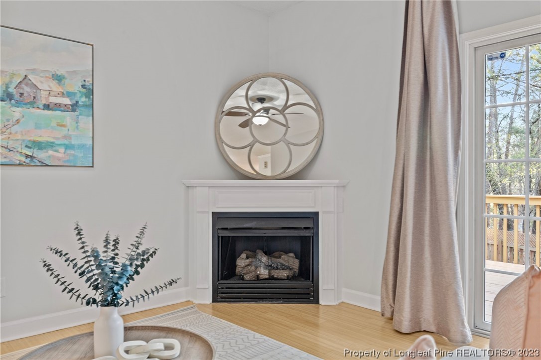 45 Sawmill Road West Pinehurst, NC 28374 - Photo 5 of 36 a living room with a fireplace and a large window