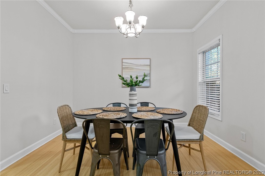 45 Sawmill Road West Pinehurst, NC 28374 - Photo 7 of 36 a view of a dining room with furniture a chandelier and wooden floor