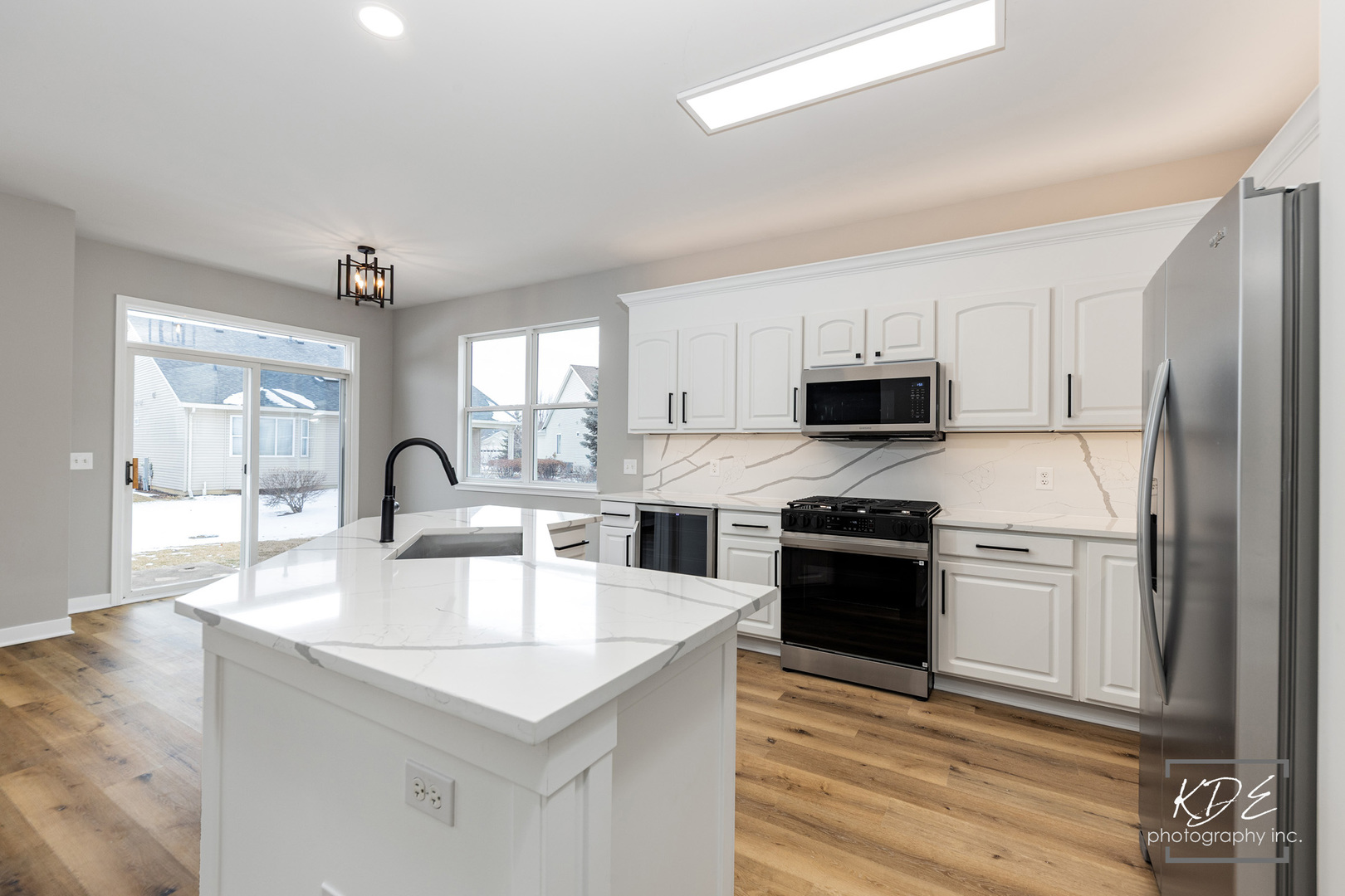 733 Mecosta Lane Romeoville, IL 60446 - Photo 11 of 36 a kitchen with stainless steel appliances granite countertop a stove a sink and a refrigerator
