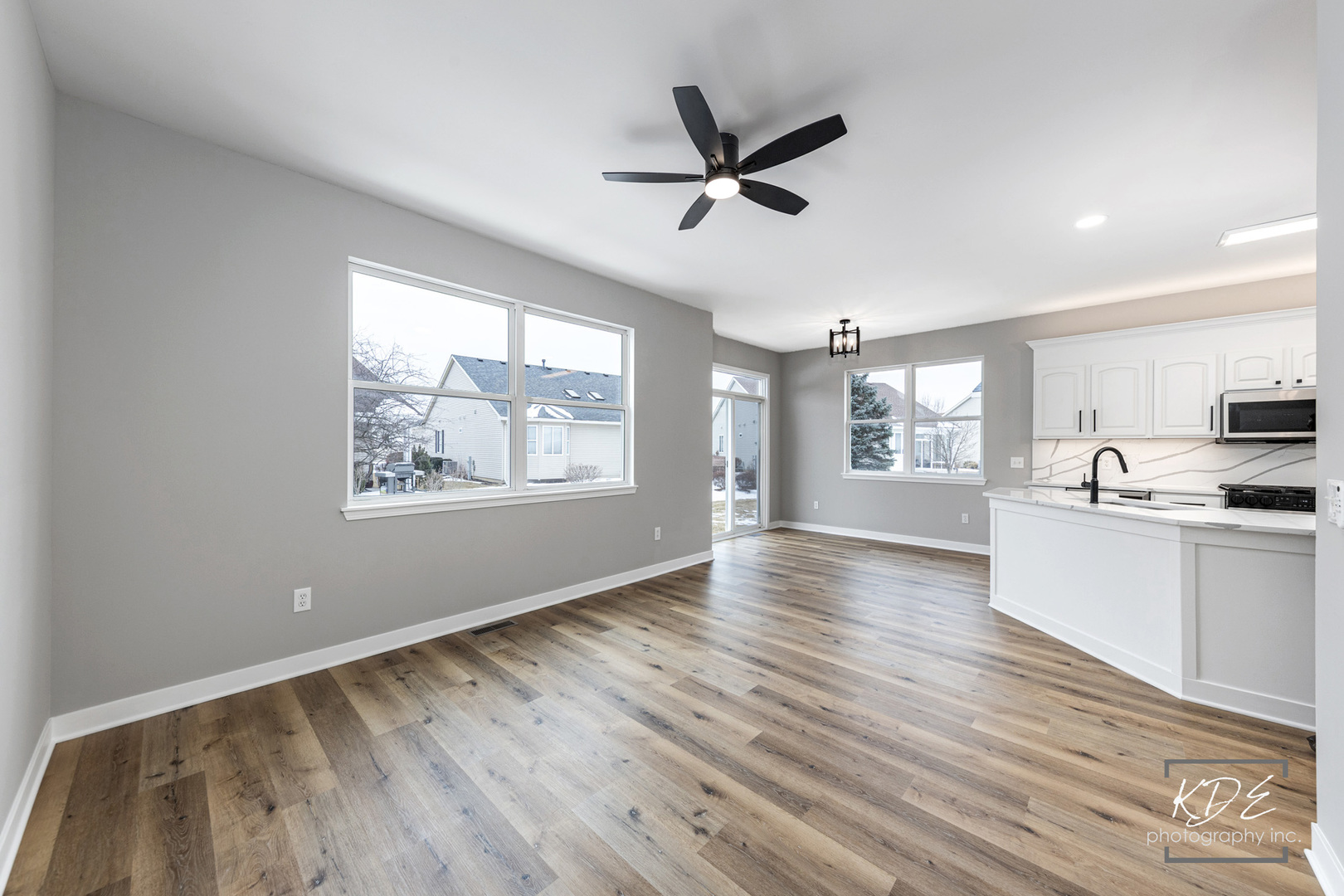 733 Mecosta Lane Romeoville, IL 60446 - Photo 14 of 36 a view of a big room with wooden floor and windows