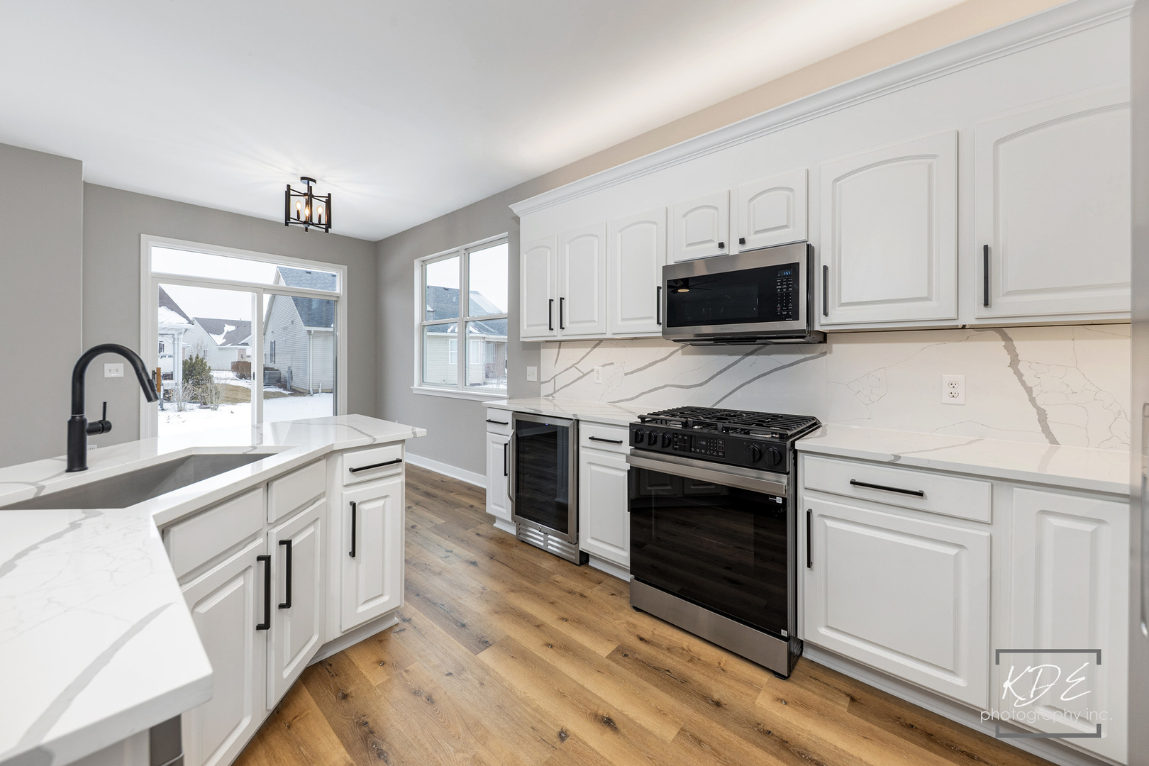 733 Mecosta Lane Romeoville, IL 60446 - Photo 10 of 36 a kitchen with stainless steel appliances a stove microwave and sink
