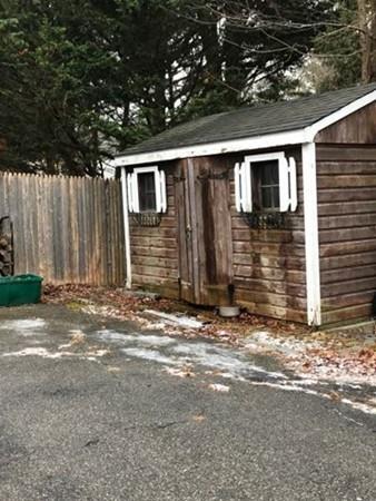 52 Puritan Road Bourne, MA 02532 - Photo 7 of 8 a backyard of a house