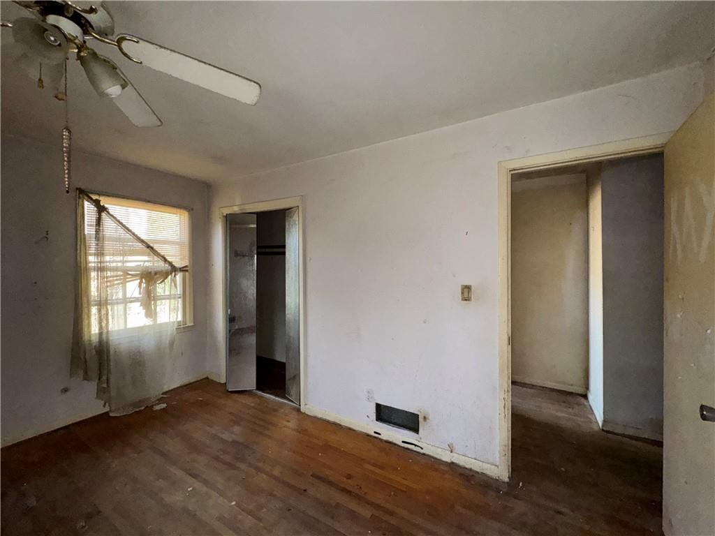 3955 Demooney Road Atlanta, GA 30349 - Photo 12 of 26 an empty room with wooden floor and windows