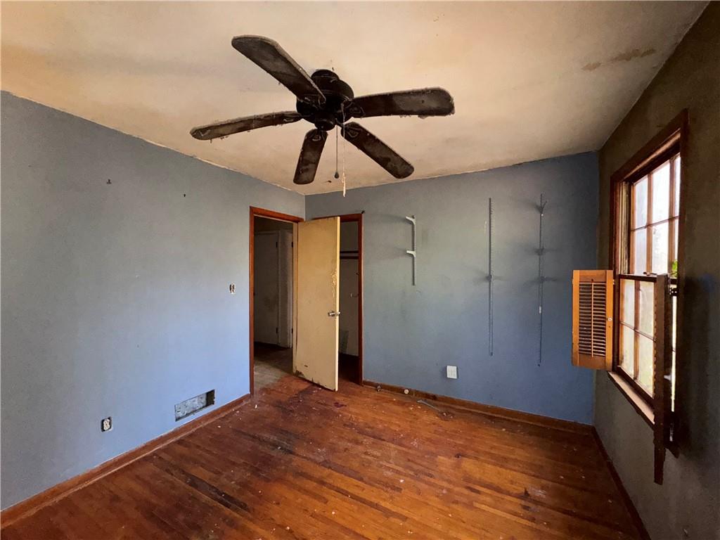 3955 Demooney Road Atlanta, GA 30349 - Photo 13 of 26 a view of an empty room with a window and wooden floor