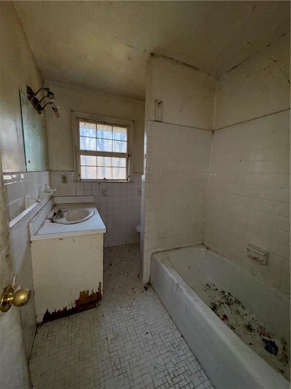 3955 Demooney Road Atlanta, GA 30349 - Photo 14 of 26 a bathroom with a sink a toilet and shower
