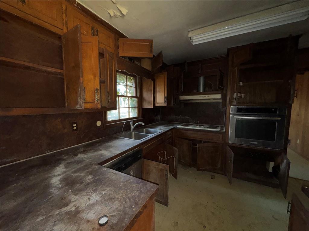 3955 Demooney Road Atlanta, GA 30349 - Photo 18 of 26 a kitchen with a sink stove and microwave