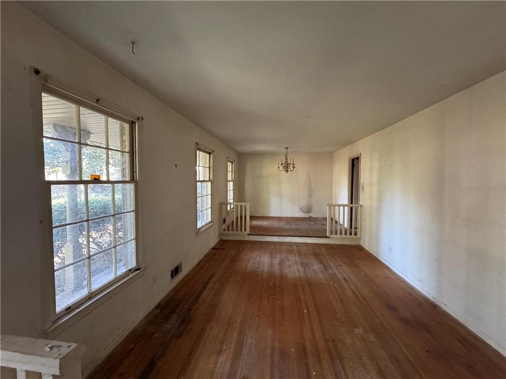 3955 Demooney Road Atlanta, GA 30349 - Photo 7 of 26 a view of an empty room with wooden floor and a window