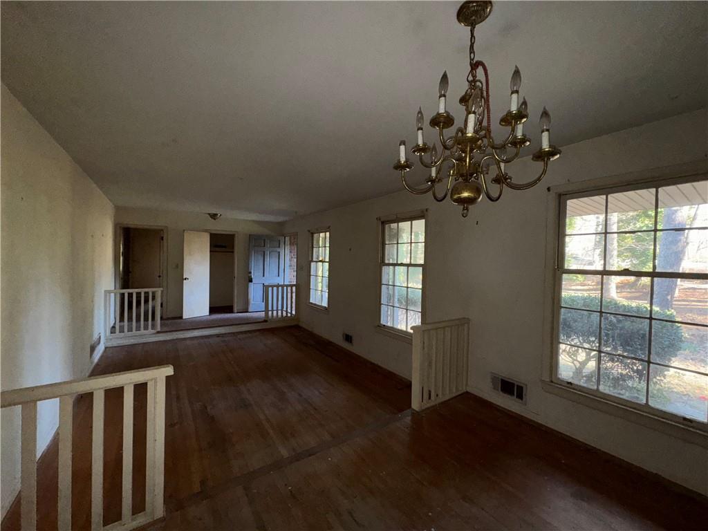 3955 Demooney Road Atlanta, GA 30349 - Photo 9 of 26 a view of an empty room with wooden floor and a window