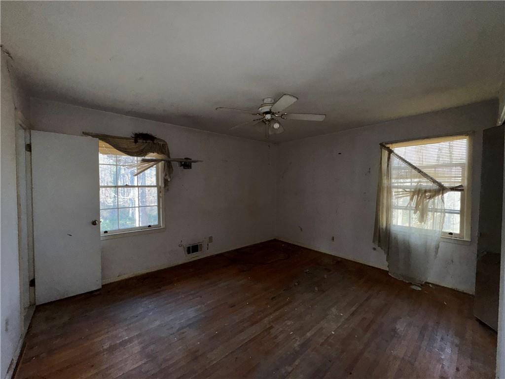 3955 Demooney Road Atlanta, GA 30349 - Photo 10 of 26 an empty room with wooden floor and windows