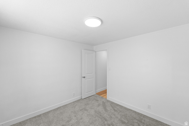 2600 North Hill Field Road, Unit 103A Layton, UT 84041 - Photo 21 of 31 Neutral wall color with baseboard trim, plush carpet, and a flush-mount ceiling light fixture
