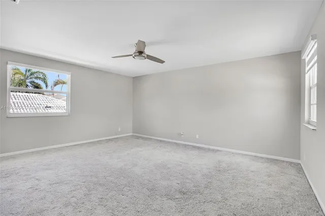 a view of room with a ceiling fan and window