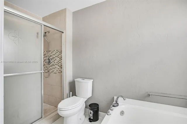 a white toilet sitting next to a bathroom sink