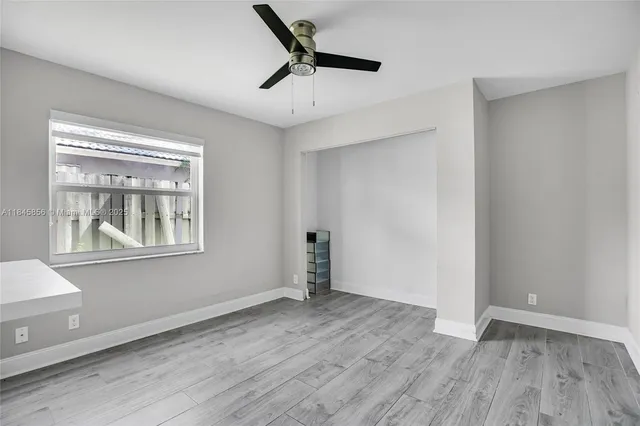 wooden floor in an empty room with a window