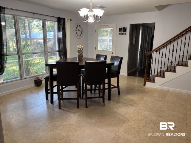 7310 Cook Road Foley, AL 36535 - Photo 13 of 14 Dining area with a chandelier and stairway
