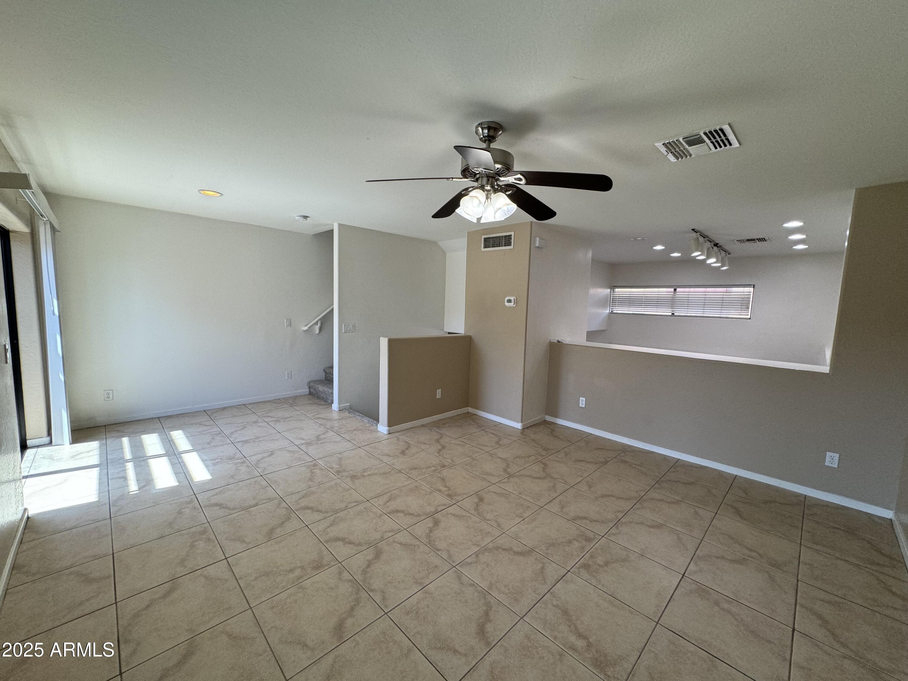 305 South Wilson Street, Unit 111 Tempe, AZ 85281 - Photo 39 of 48 a view of a livingroom with a ceiling fan and window