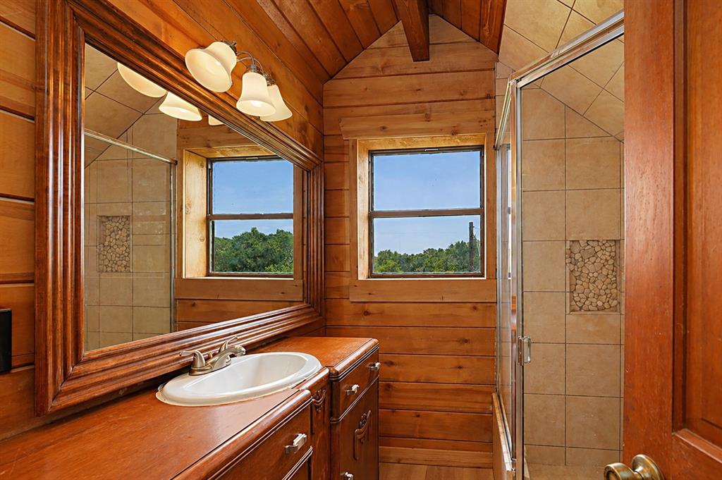 371 Spring Street Forestburg, TX 76239 - Photo 24 of 38 a bathroom with a sink a mirror and a shower