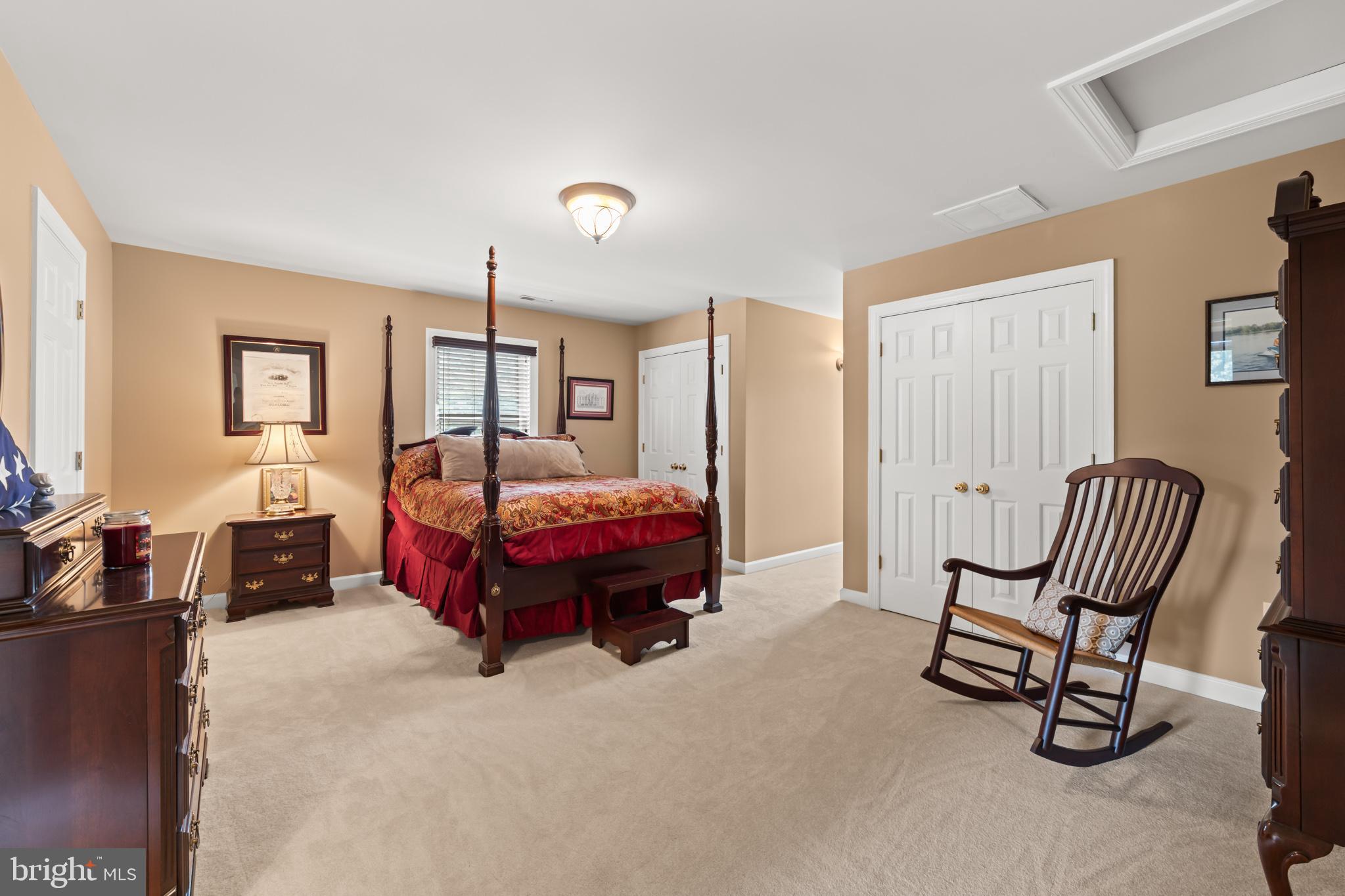 1688 Desert Road Reva, VA 22735 - Photo 38 of 81 a spacious bedroom with a bed and a chandelier