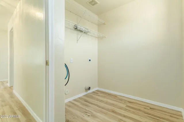 a view of a house with a yard and potted plants