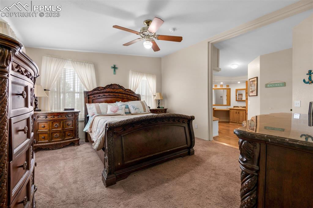 28230 Washington Road Calhan, CO 80808 - Photo 14 of 40 a bedroom with a bed and a chandelier