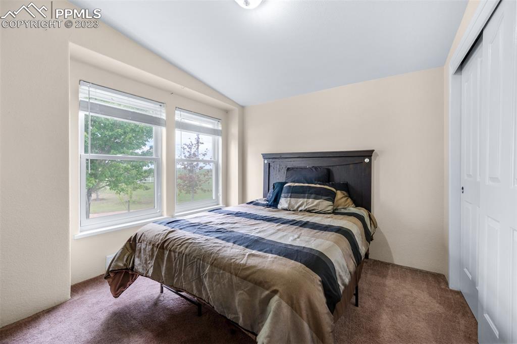 28230 Washington Road Calhan, CO 80808 - Photo 17 of 40 a bedroom with a bed and a window