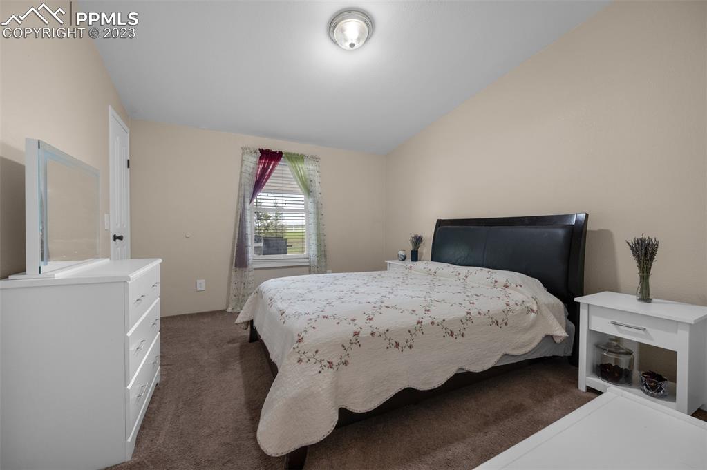 28230 Washington Road Calhan, CO 80808 - Photo 18 of 40 a bedroom with a bed and a window