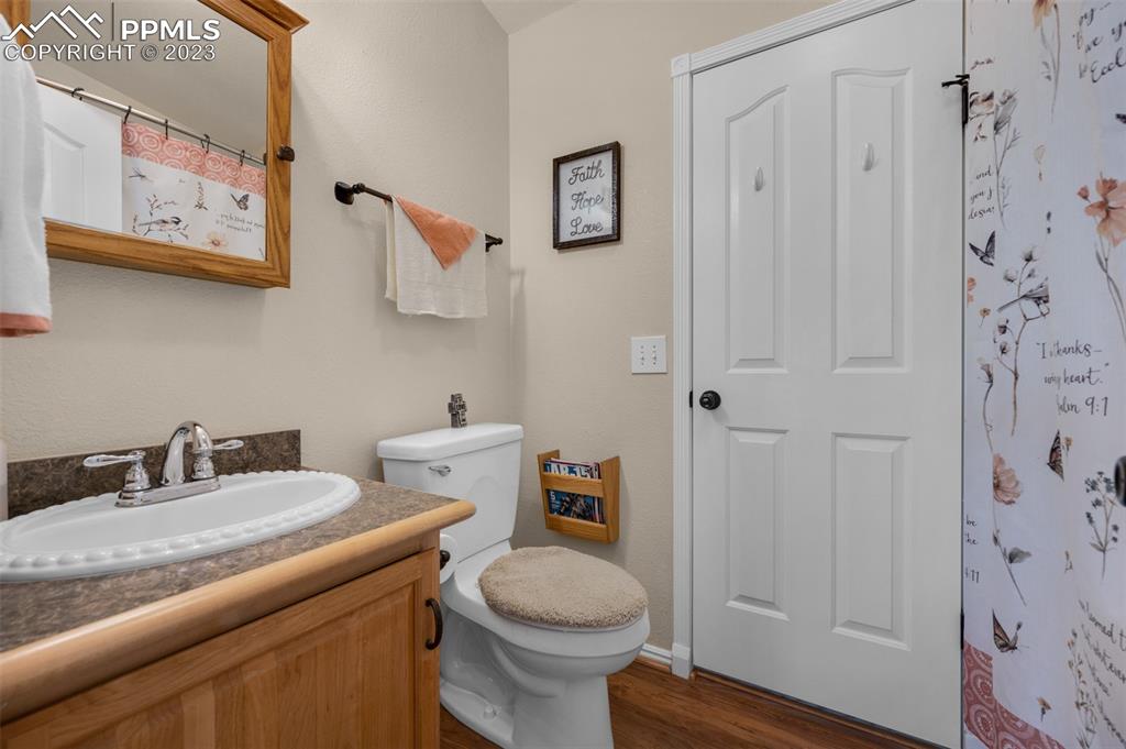 28230 Washington Road Calhan, CO 80808 - Photo 19 of 40 a bathroom with a granite countertop toilet sink and mirror
