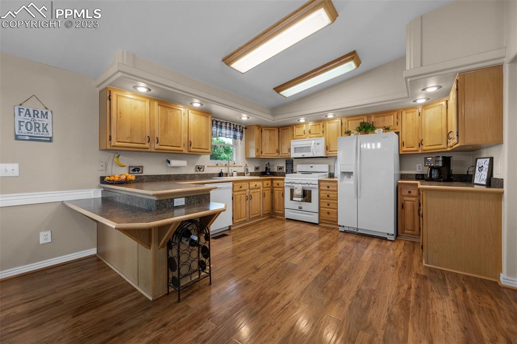 28230 Washington Road Calhan, CO 80808 - Photo 2 of 40 a kitchen with wooden floors and refrigerator