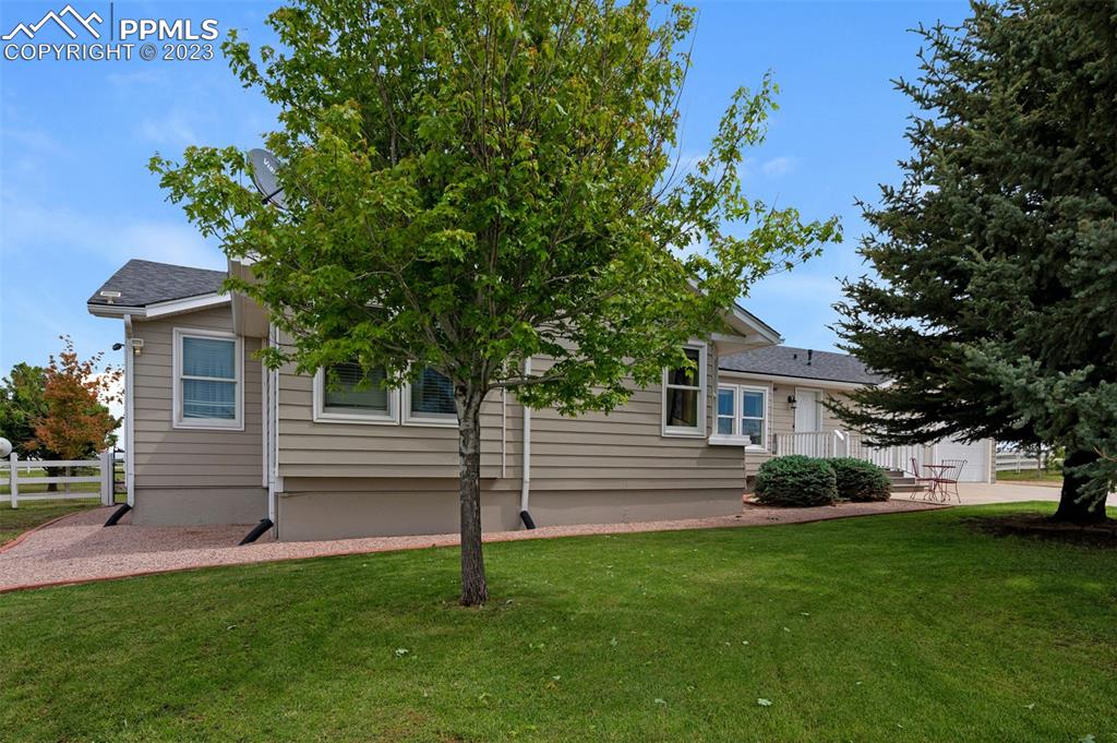 28230 Washington Road Calhan, CO 80808 - Photo 35 of 40 a front view of a house with a garden